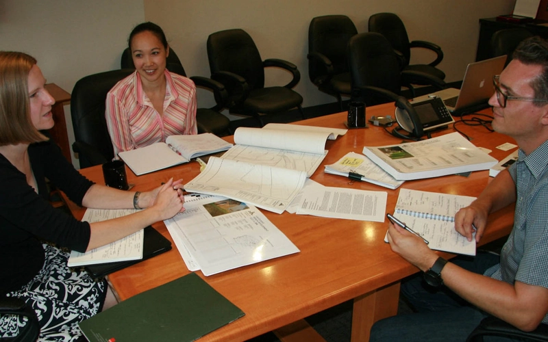 Academic researchers meet with a firm liaison to discuss a research project