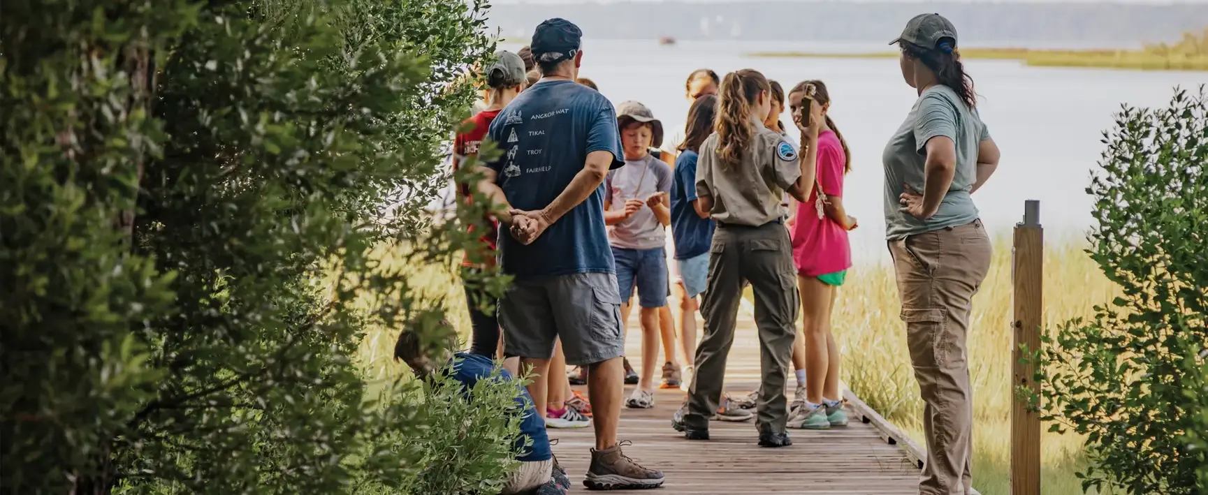 A group of visitors at Machicomoco State Park listening to a park guide