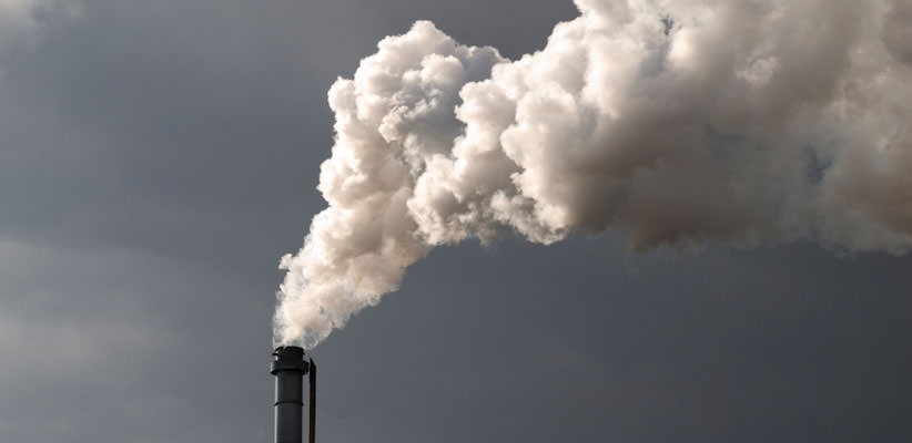 Single smokestack billowing smoke into the air