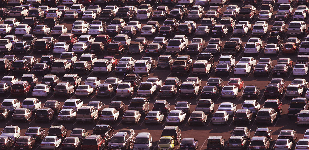 Parking lot packed full of cars with a red overlay over the entire image